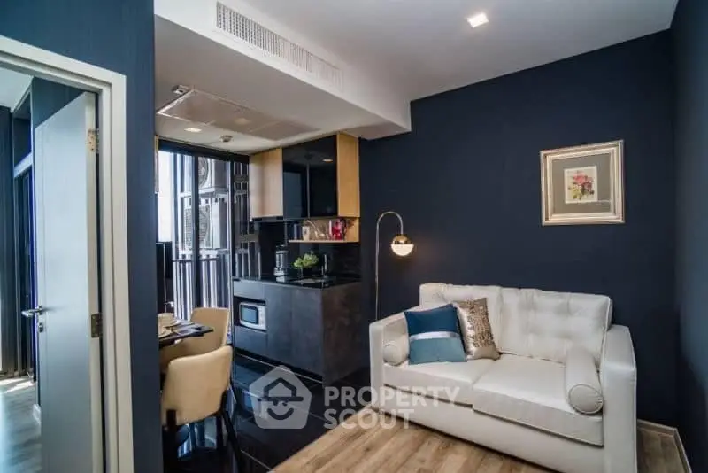 Modern living room with stylish decor and open kitchen layout in a contemporary apartment.