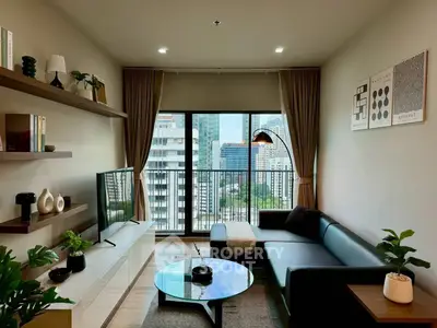 Modern living room with city view, stylish decor, and cozy seating area in urban apartment.
