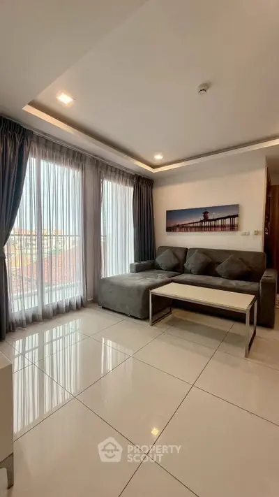 Spacious living room with modern decor and large windows for natural light.
