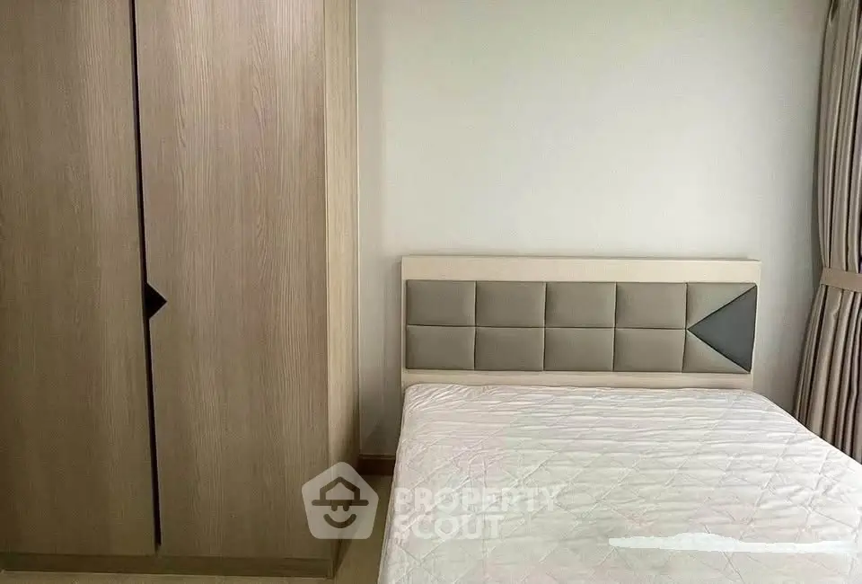 Modern bedroom with stylish wardrobe and cozy bed in a bright apartment.