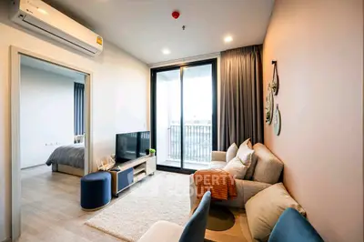 Modern living room with balcony access and cozy decor