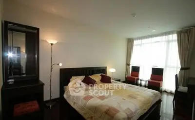 Spacious bedroom with large window and modern decor