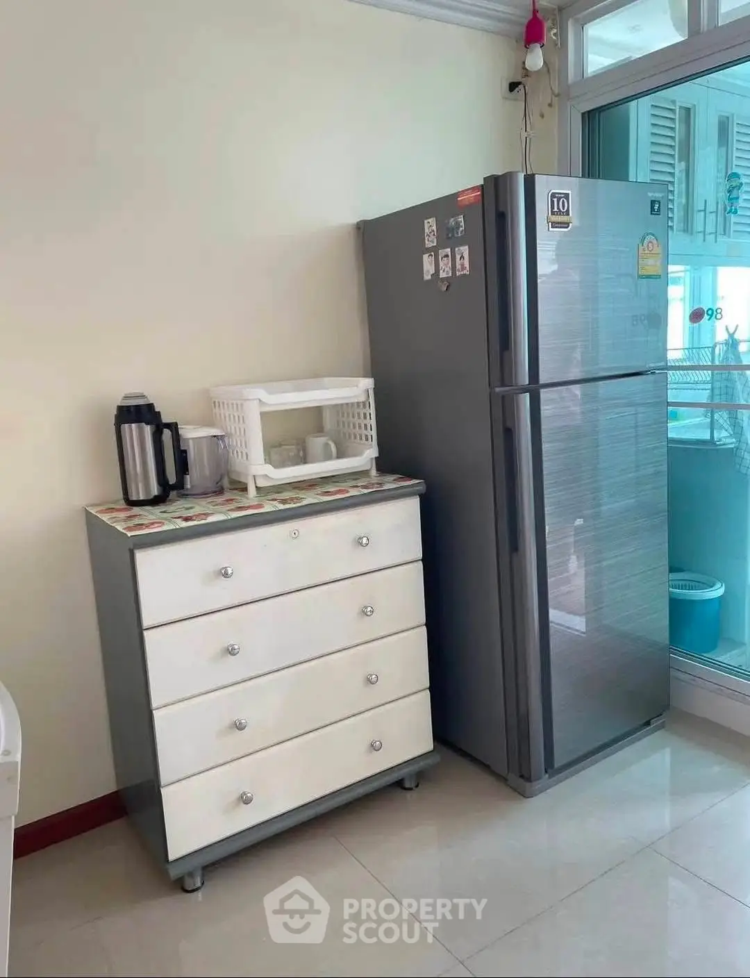 Modern kitchen corner with sleek fridge and storage drawers