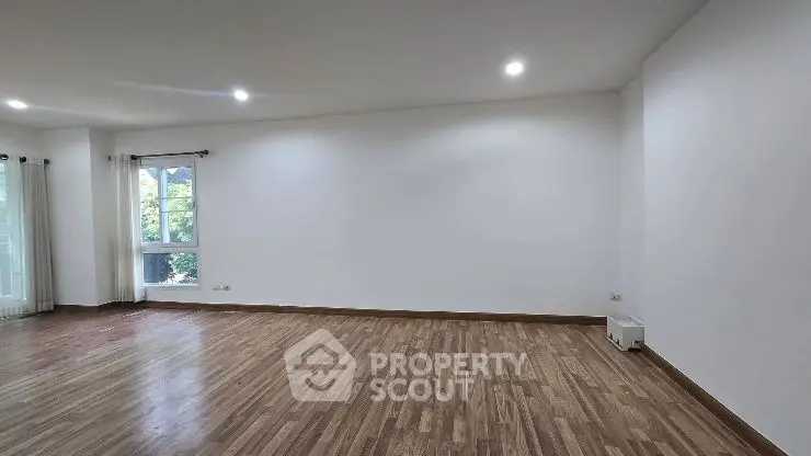 Spacious modern living room with wooden flooring and recessed lighting