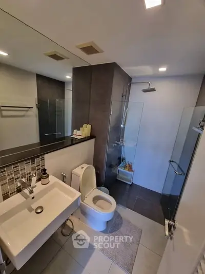 Modern bathroom with sleek fixtures and glass shower enclosure