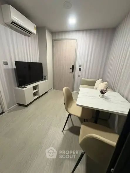 Modern living room with dining area and sleek furniture in a cozy apartment.