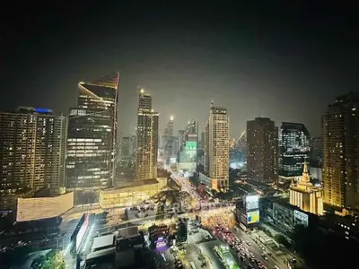Stunning cityscape view of illuminated skyscrapers at night, showcasing urban luxury and vibrant city life.