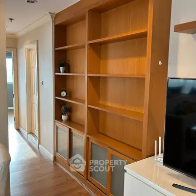 Spacious living room with elegant wooden shelving and modern decor