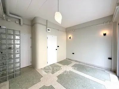 Modern minimalist room with unique flooring and glass block wall