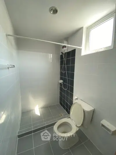 Modern minimalist bathroom with shower and natural light