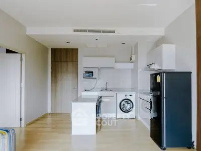 Modern kitchen with sleek appliances and open layout in a stylish apartment.