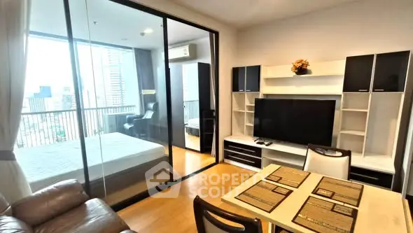 Modern apartment interior with open living room and bedroom, city view balcony.