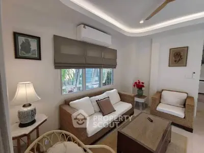 Charming living room with cozy wicker furniture and elegant decor, perfect for relaxation and entertaining.