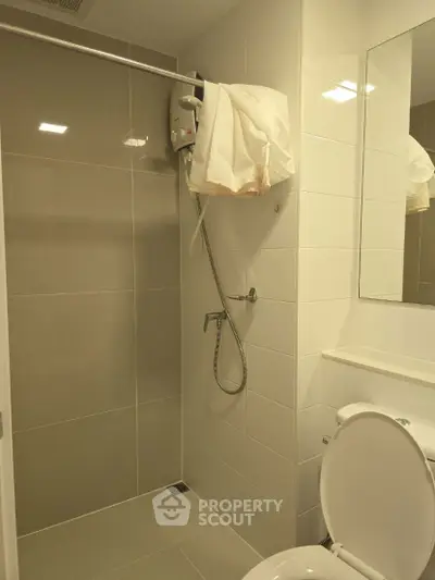 Modern bathroom with sleek shower and neutral tiles