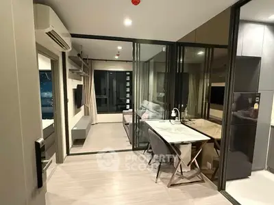 Modern apartment interior with glass partition and sleek furniture