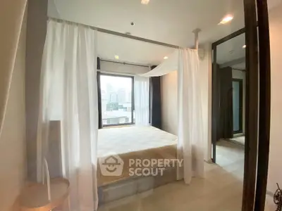Luxurious bedroom with city view and elegant canopy bed in modern apartment.