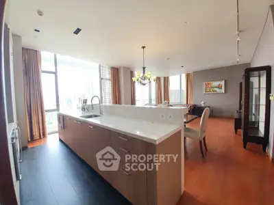 Spacious open-layout kitchen and dining area with modern design and city view.