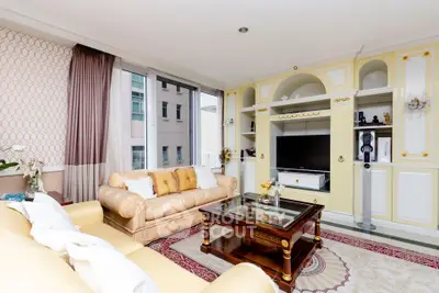 Luxurious living room with elegant decor and large windows in a modern apartment.