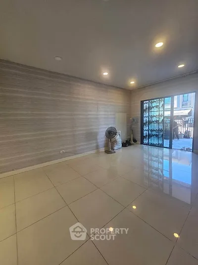 Spacious unfurnished living room with tiled flooring and sliding glass doors