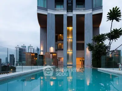 Luxurious high-rise building with stunning pool and cityscape view, perfect for modern urban living.