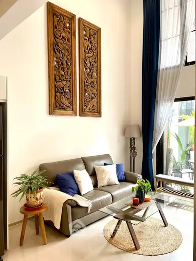 Elegant living room with high ceilings, modern furniture, and large windows for natural light.