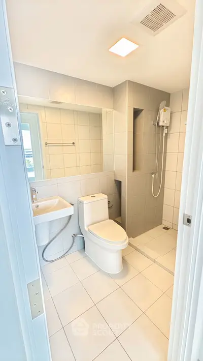 Modern bathroom with sleek fixtures and a spacious shower area.