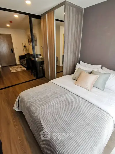 Modern bedroom with stylish decor and mirrored wardrobe in a cozy apartment