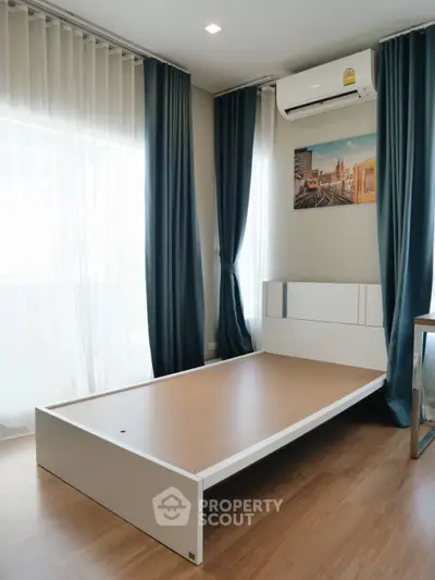 Modern bedroom with sleek bed frame and air conditioning, featuring floor-to-ceiling windows and elegant curtains.