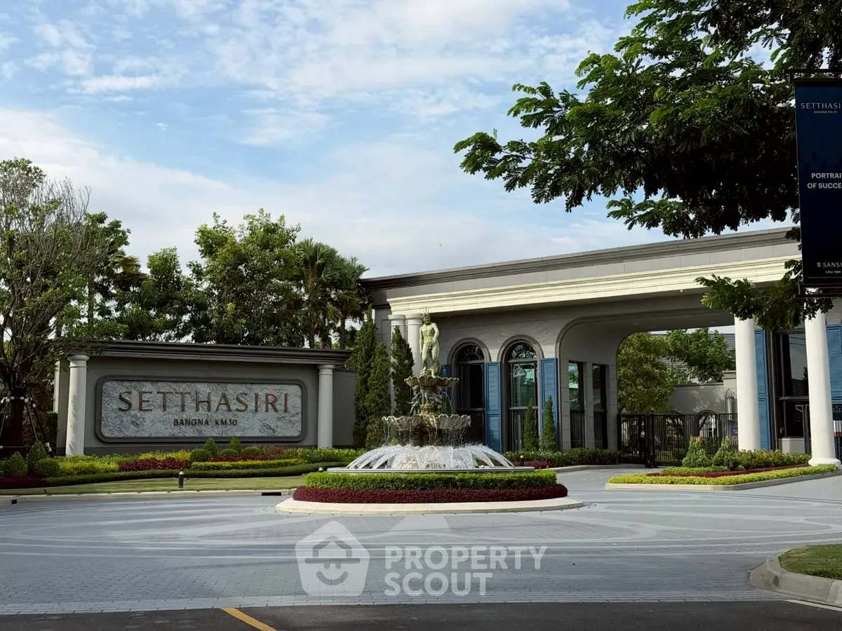 Luxurious gated entrance of Sethasiri housing estate with elegant fountain and lush greenery.