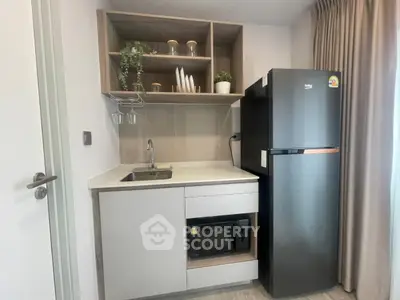Modern compact kitchen with sleek appliances and stylish storage solutions.