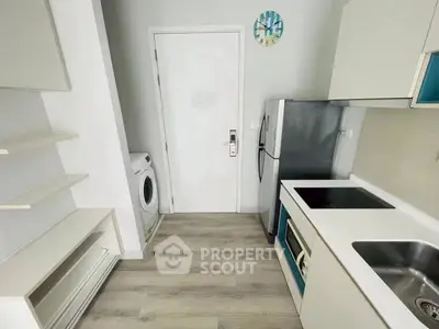 Modern compact kitchen with washing machine and sleek appliances