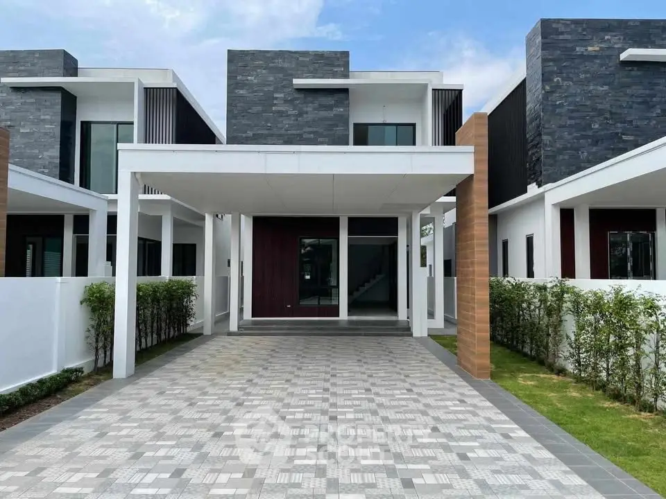 Modern two-story house with sleek facade and spacious driveway