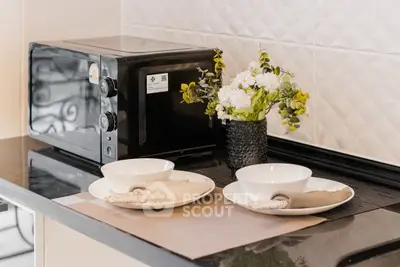 Modern kitchen with microwave and elegant table setting, perfect for stylish dining.
