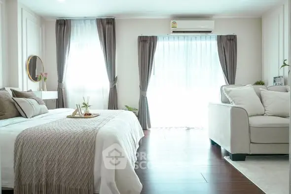 Spacious bedroom with elegant decor and natural light