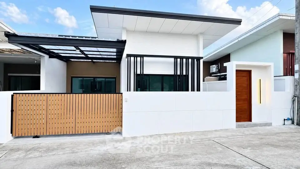 Modern minimalist house exterior with sleek design and gated entrance