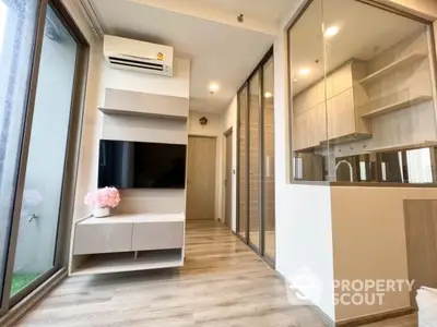 Modern living room with glass partition and sleek wooden flooring