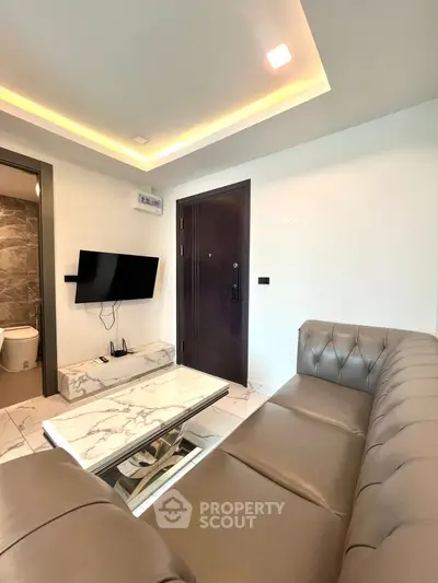 Modern living room with sleek furniture and marble coffee table