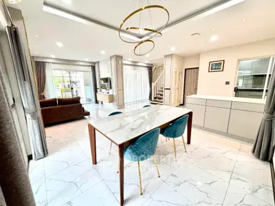 Luxurious open-plan living and dining area with modern furnishings and elegant lighting.
