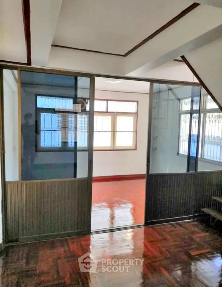 Spacious interior with sliding glass doors and polished wooden floors