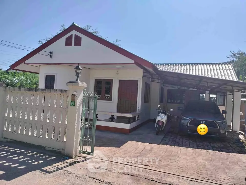 Charming single-story house with carport and gated entrance, perfect for cozy living.