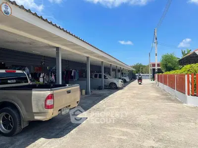 Spacious parking area with covered spaces and clear blue sky.