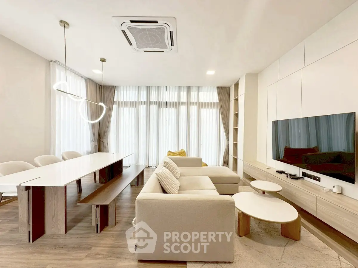 Modern living room with sleek furniture and large windows for natural light