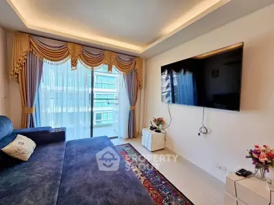 Luxurious living room with elegant drapes, modern TV setup, and plush sofa in a high-rise apartment.