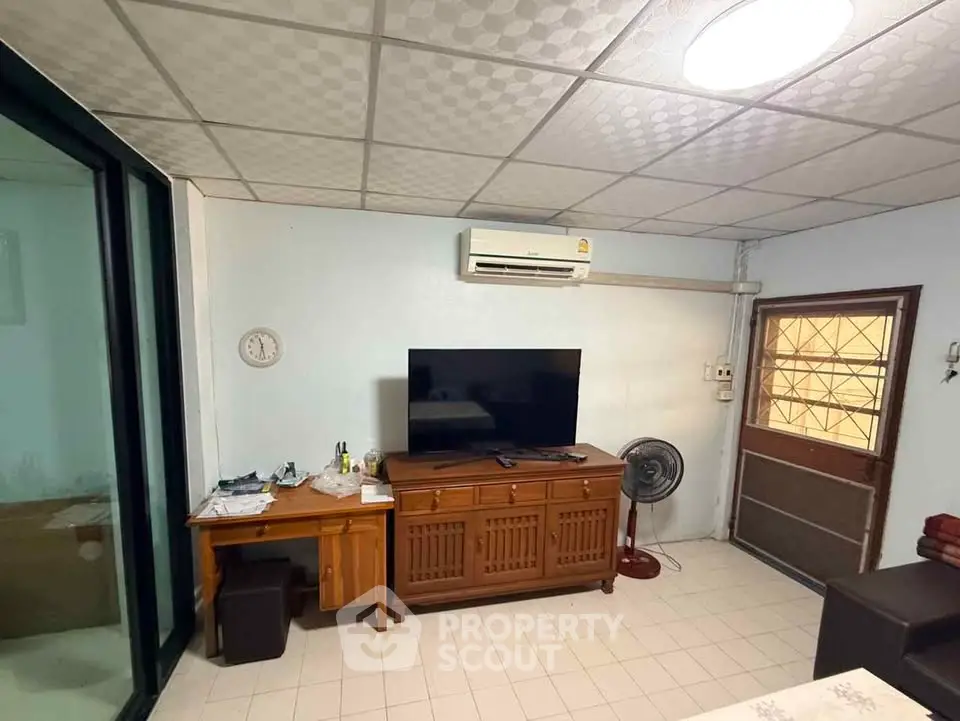 Cozy living room with air conditioning and TV setup, perfect for relaxation.