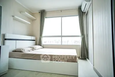 Bright and modern bedroom with large window and minimalist design.