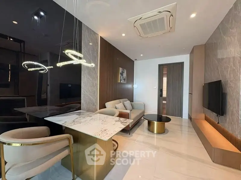 Luxurious modern living room with elegant marble dining table and stylish lighting fixtures.