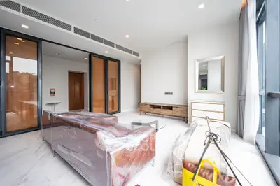 Modern living room with sleek furniture and large windows offering natural light