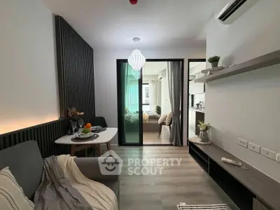 Modern living room with stylish decor and open view into cozy bedroom