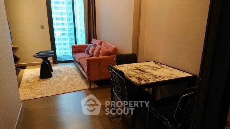 Stylish modern living room with elegant furniture and city view balcony.