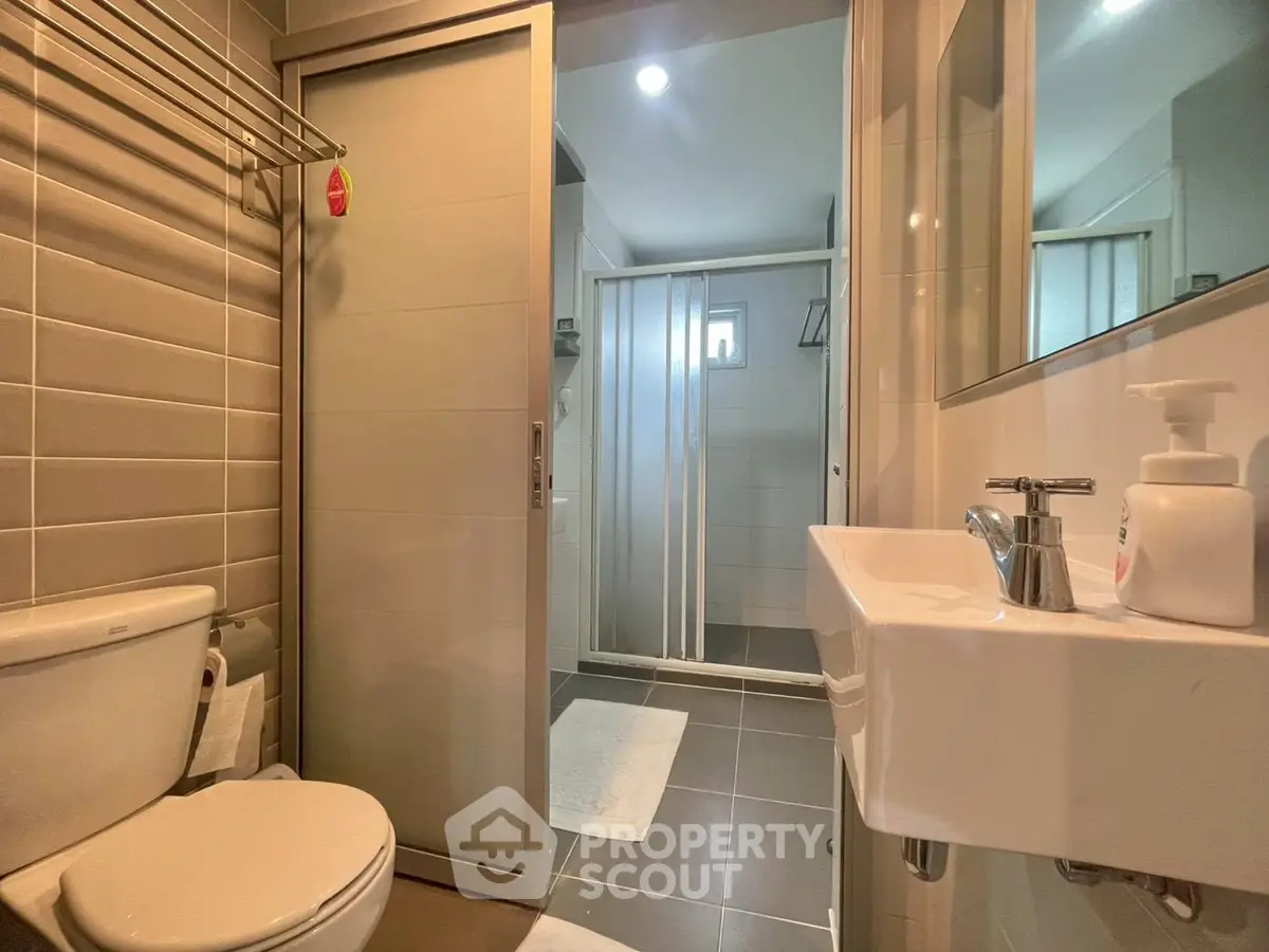 Modern bathroom with sleek fixtures and spacious shower area